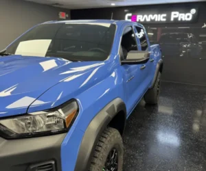 displaying its reflective paint and off-road tires, referencing car detailing