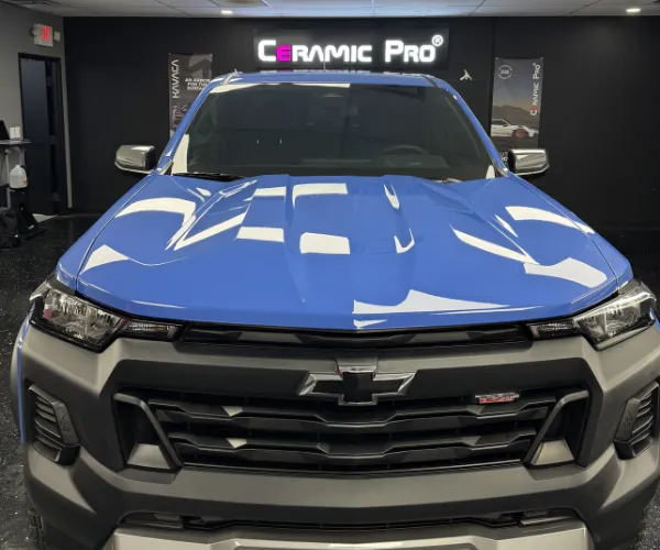 displaying its reflective paint and off-road tires, referencing car detailing