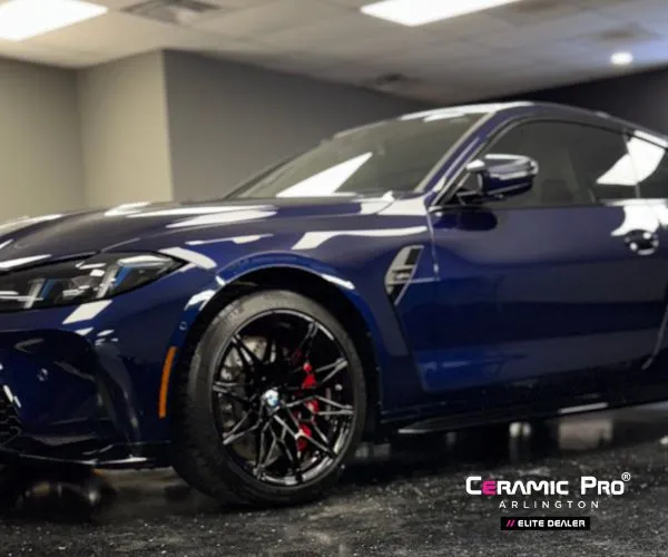 iew of the dark blue BMW coupe showcasing the full side profile